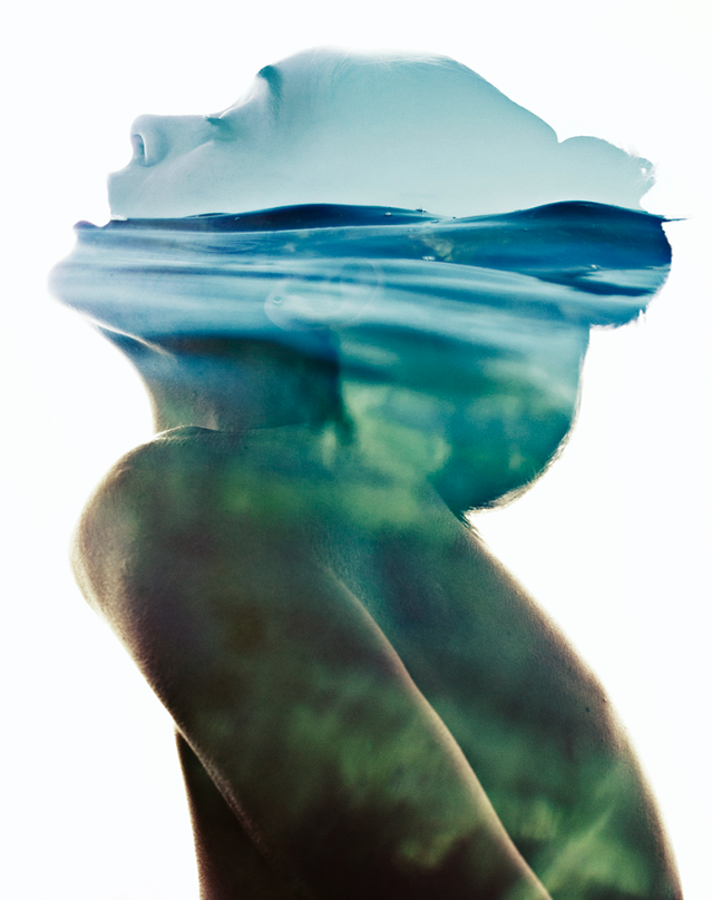 Double exposure of a woman in profile seamlessly blended with ocean waves, evoking a serene and artistic atmosphere.